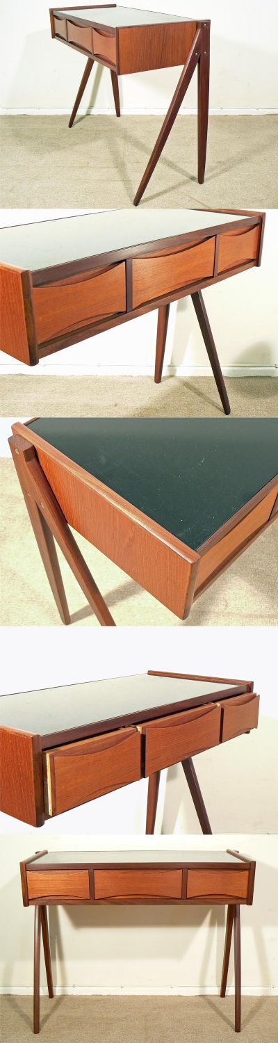 A teak side table, c1960s. Black glass top above three draws and standing on a split leg section. 