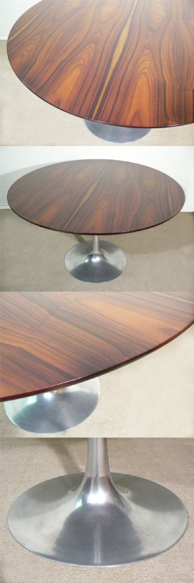 A circular rosewood table c1970s. In the manner of Saarinen, on a cast metal pedastool with superb, vivid grain.